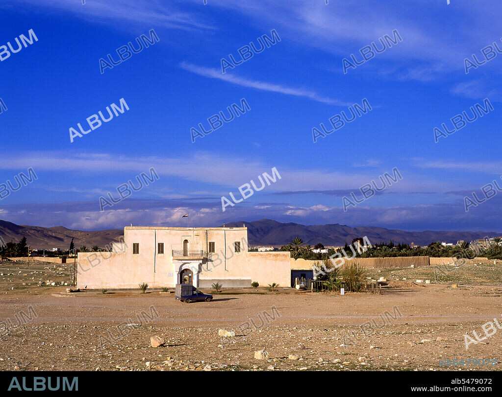 Palmyra was an ancient city in Syria. It was an important city in central Syria, located in an oasis 215 km northeast of Damascus and 180 km southwest of the Euphrates at Deir ez-Zor. It had long been a vital caravan city for travellers crossing the Syrian desert and was known as the Bride of the Desert. The earliest documented reference to the city by its Semitic name Tadmor, Tadmur or Tudmur (which means 'the town that repels' in Amorite and 'the indomitable town' in Aramaic) is recorded in Babylonian tablets found in Mari.