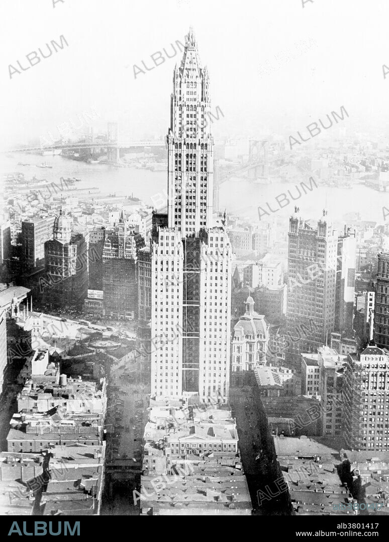 The Woolworth Building, at 233 Broadway, Manhattan, New York City, designed by architect Cass Gilbert in the neo-Gothic style commissioned in 1910 to design a 20 story office building as the F. W. Woolworth Company's new corporate headquarters on Broadway, between Park Place and Barclay Street in Lower Manhattan, opposite City Hall. Originally designed to be 420 feet high, the building was eventually elevated to 792 feet. At its opening, the Woolworth Building was 60 stories tall and had over 5,000 windows. The construction cost was US$13.5 million. More than a century after the start of its construction, it remains one of the 100 tallest buildings in the United States as well as one of the 30 tallest buildings in New York City. It has been a National Historic Landmark since 1966, and a New York City landmark since 1983. No photographer credited, 1923.