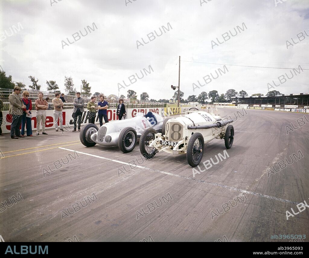 A 1914 and 1937 Grand Prix Mercedes racing car at the starting line. The first ever 1-2-3 finish in a grand prix was achieved by Mercedes in 1914 with the model on the right at the French Grand Prix at Lyons. The car on the left is a   Mercedes-Benz W125 car and was the most powerful Grand Prix car at the time.