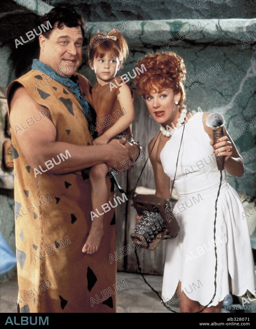 ELIZABETH PERKINS and JOHN GOODMAN in THE FLINTSTONES, 1994, directed by BRIAN LEVANT. Copyright UNIVERSAL PICTURES / BATZDORFF, RON.