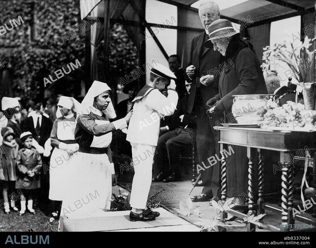 Princess Helena Victoria Attends Garden Party -- Princess Helena Victoria receiving purses during the party. Princess Helena Victoria received purses at the Garden Party in the grounds of the South London Hospital held in aid of the Hospital. January 01, 1931.