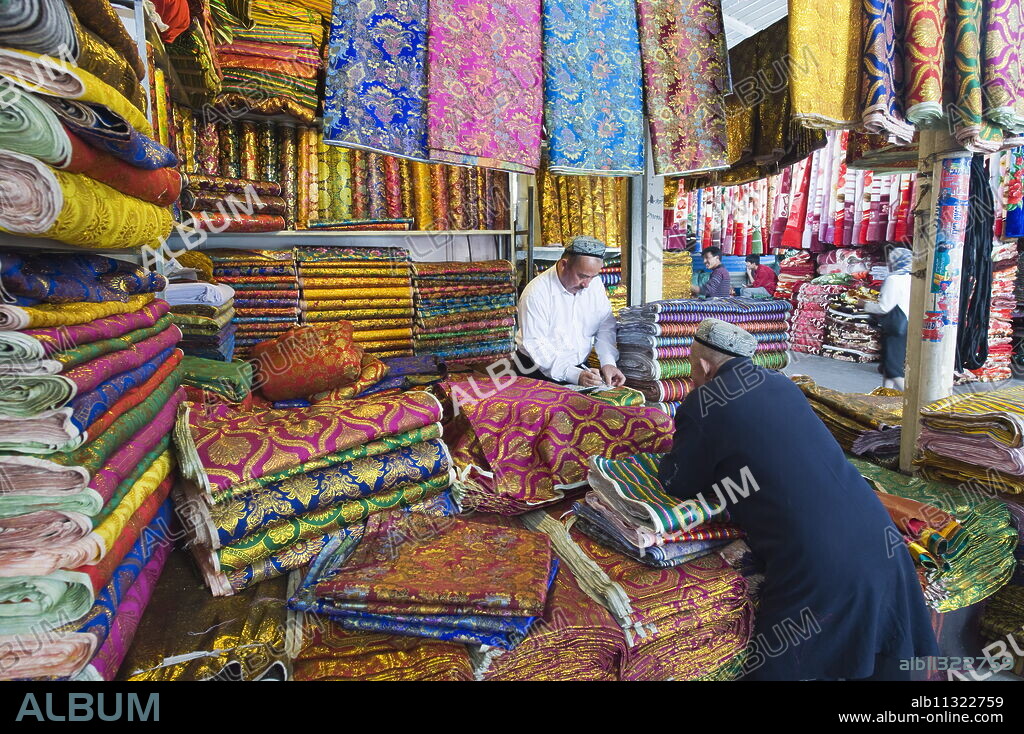 Silk fabrics being sold at the Sunday market, Kashgar (Kashi), Xinjiang Provice, China, Asia.