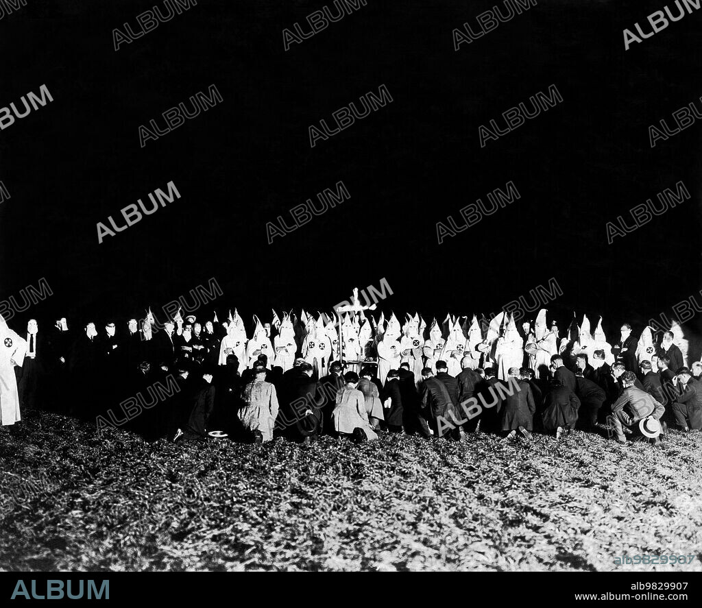United States, September 8, 1922, A Ku Klux Klan meeting with initiates kneeling.