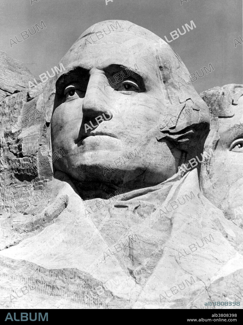 George Washington's head was started first. Due to the economic instability of the United States caused by the Great Depression, it was completed in seven years, and dedicated to the public on Independence Day 1934. A large American flag was placed over Washington's head before it was revealed, and this became a tradition for each of the Presidents' heads. Mount Rushmore National Memorial is a sculpture carved into the granite face of Mount Rushmore near Keystone, South Dakota. Sculpted by Danish-American Gutzon Borglum and his son, Lincoln Borglum, Mount Rushmore features 60 foot sculptures of the heads of four United States presidents: George Washington, Thomas Jefferson, Theodore Roosevelt, and Abraham Lincoln. Construction on the memorial began in 1927, and the presidents' faces were completed between 1934 and 1939. Although the initial concept called for each president to be depicted from head to waist, lack of funding forced construction to end in late October 1941. Mount Rushmore has become an iconic symbol of the United States, and attracts over three million people annually. NPS, no photographer credited, undated.