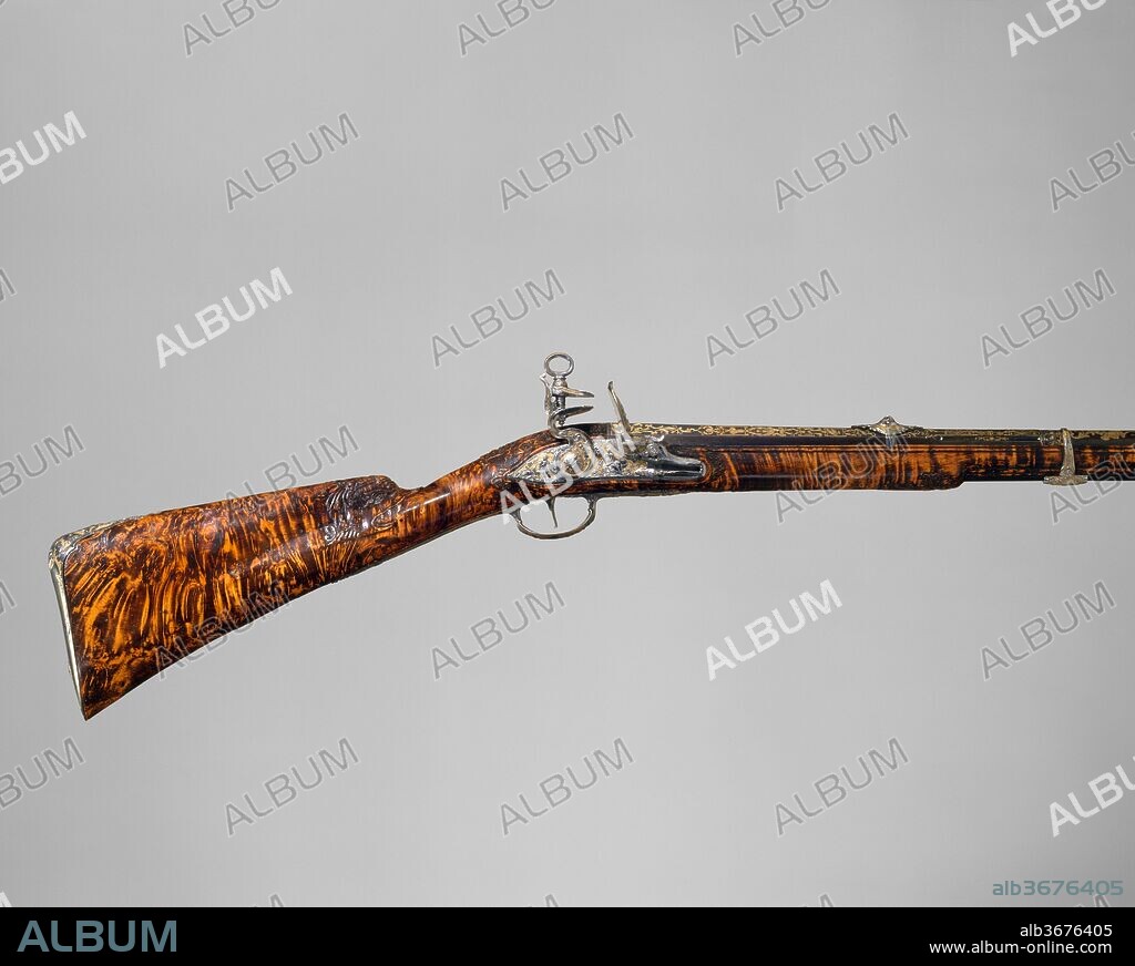 Gun with Flintlock a la moda. Culture: Spanish, Madrid. Dimensions: L. of barrel 38 3/4 in. (98.4 cm). Gunsmith: Gabriel de Algora (Spanish, Madrid, documented 1733-died 1761). Date: dated 1744.
One of Algora's masterpieces, this hunting gun is decorated with figures from Classical mythology chiseled in bright steel against a matte gold ground in the French style.