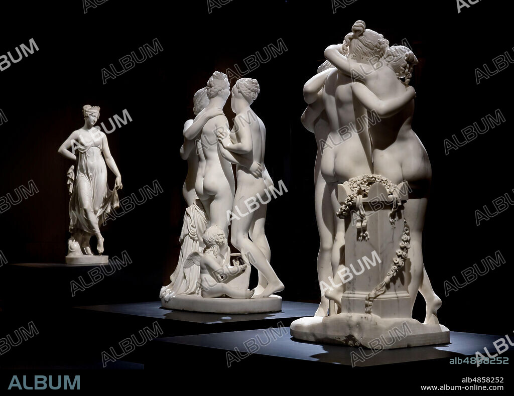 Three statuary groups: in the foreground, "The three Graces", 1812-17, by Antonio Canova (1757 - 1822), marble statue. At the centre, "The Graces and Cupid", 1820 -22 by Bertel Thorvaldsen (1770-1844) . In the background, "Dancing Terpsichore (Dancer), 1820, di Gaetano Matteo Monti (1776 - 1847).