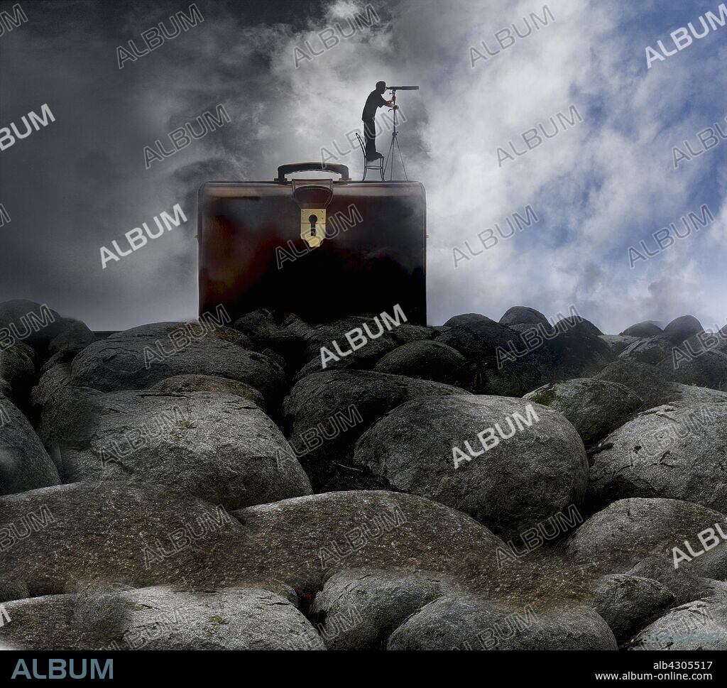 Man standing on top of briefcase looking through telescope to brighter sky.