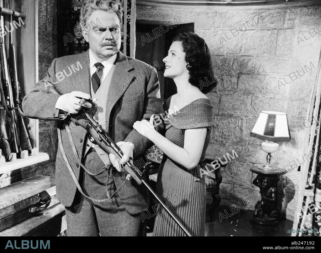 MARGARET LOCKWOOD and ORSON WELLES in TROUBLE IN THE GLEN, 1954. Copyright REPUBLIC PICTURES.