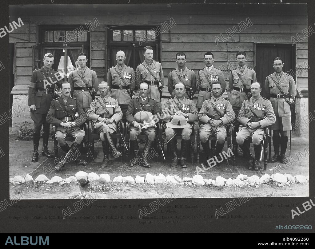 RANDOLPH BEZZANT HOLMES. [Military group at Landi Khana.] 18 February 1926. Formally posed group portrait of British officers, taken after the unveiling of the Gurkha Centenary Bell. The sitters are identified as follows (Standing): Capt. Baird (Staff Captain); 2/Lieut L.G. Forster; Capt. G.E.R.S. Hartigan M.C.; Lieut. H.E. Garland; Capt. & Adjt. H.O. Skone; Capt. C.J. Morris; 2/Lieut H.V. Rose; 2/Lieut. R.L. Whyte. (Seated): Capt. Whittuck M.C. (Bde. Major); Colonel C.H.A. Tuck C.I.E.; Colonel Commandant Lock [sic for Loch] C.B., C.M.G., D.S.O., C.B.E.; Major J.E. Colenso; Major H.F.C. McSwiney D.S.O., M.C.; Capt. H.J. Simpson M.C. Beynon Collection: 'Unveiling of the Centenary and War Memorial Bell. 2-3rd Q.A.O. Gurkha Rifles. The Khyber, 18th February 1926. 18-Feb-26. Source: Photo 1076/2.(5).