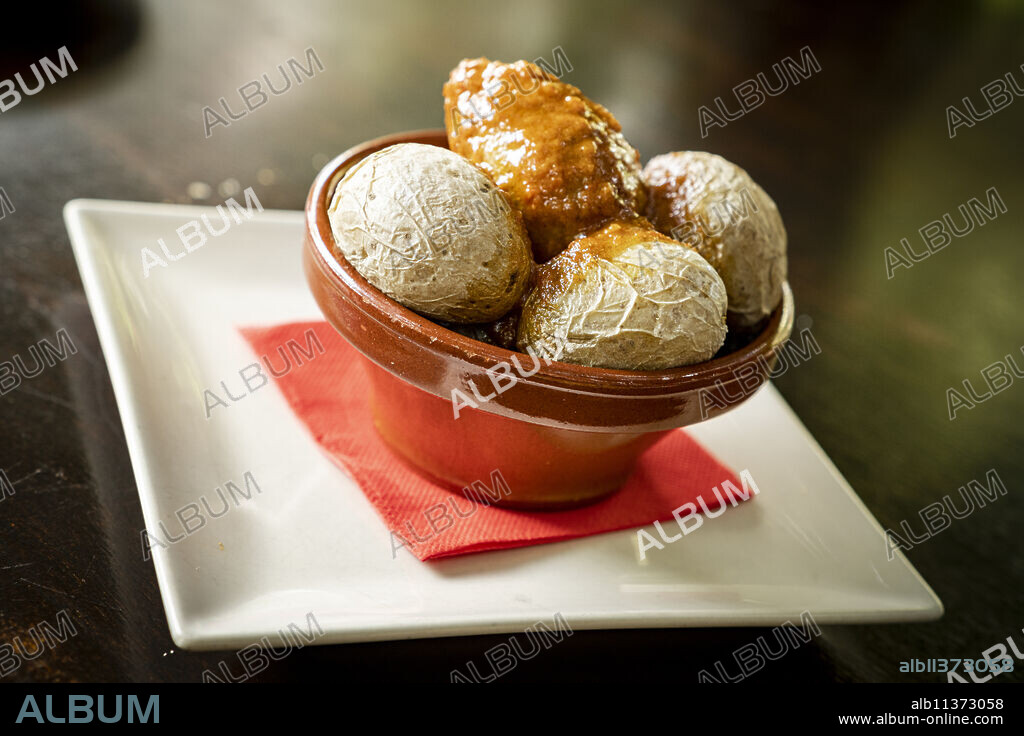 Typical wrinkled potatoes with spicy sauce in a bowl (Papas Arrugadas con Mojo Picon), Fuerteventura, Canary Islands, Spain, Europe.