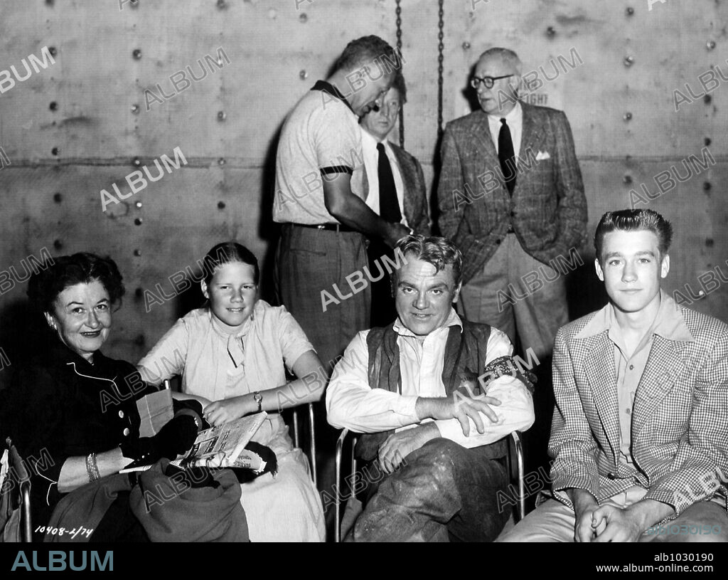 JAMES CAGNEY y NICHOLAS RAY en BUSCA TU REFUGIO, 1955 (RUN FOR COVER), dirigida por NICHOLAS RAY. Copyright PARAMOUNT PICTURES. James Cagney con su esposa y sus dos hijos. (Al fondo de perfil Nicholas Ray).