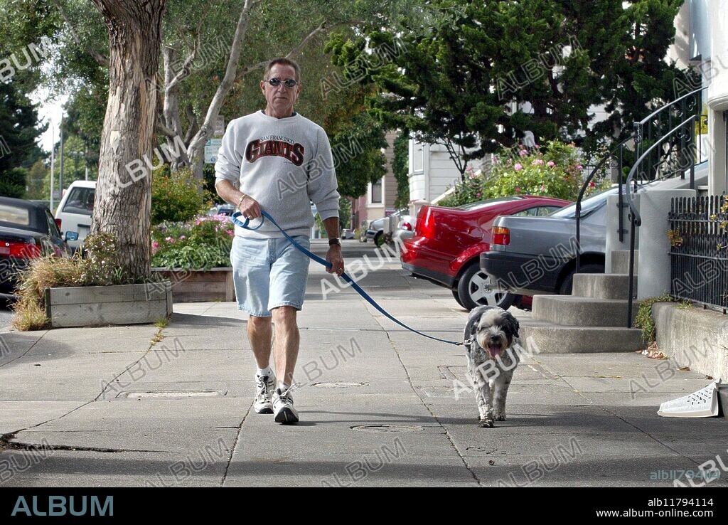 San Francisco, California --PAWS volunteer Gary Graziani walks Angel on her Thursday evening walk as other PAWS volunteers walk her either for her morning walk or afternoon walk. Angel's lives with her owner at a Hospice. San Franciscans got together to create PAWS (Pets Are Wonderful Support) in 1986 to help low income people living with AIDS and other disabling illnesses to keep their pet companions. Photo taken on Thursday, July 17, 2002.