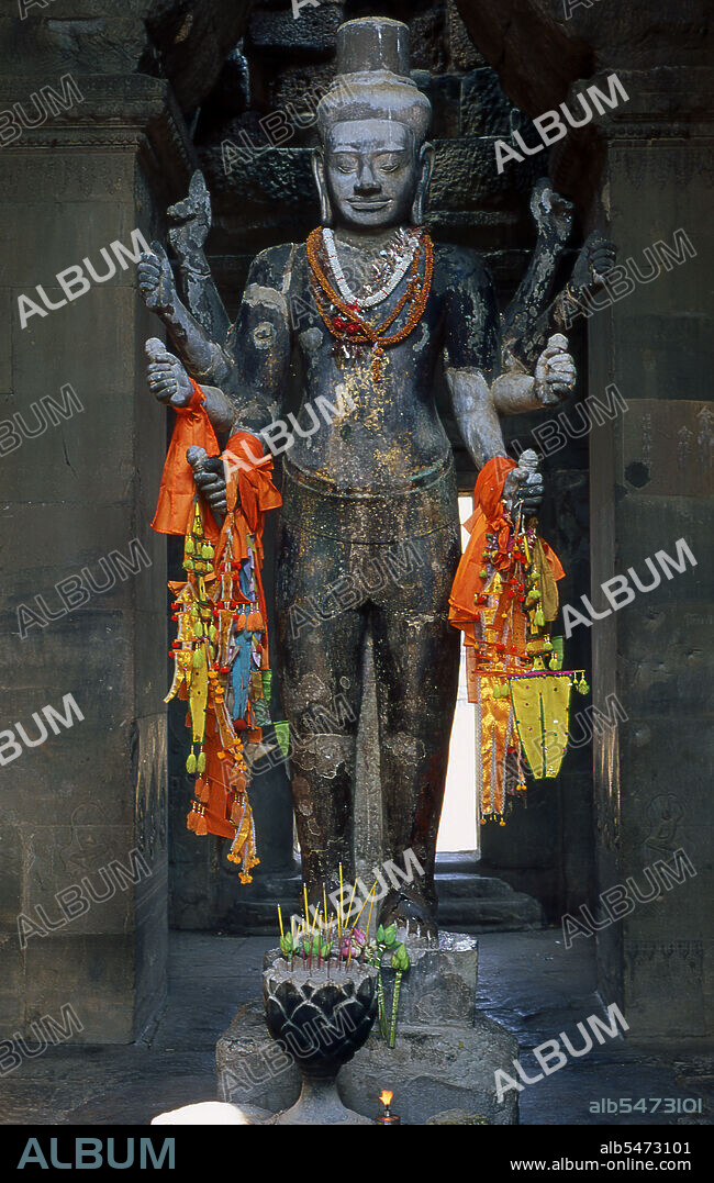 Angkor Wat was built for King Suryavarman II (ruled 1113-50) in the early 12th century as his state temple and capital city. As the best-preserved temple at the Angkor site, it is the only one to have remained a significant religious centre since its foundation - first Hindu, dedicated to the god Vishnu, then Buddhist. It is the world's largest religious building. The temple is at the top of the high classical style of Khmer architecture. It has become a symbol of Cambodia, appearing on its national flag, and it is the country's prime attraction for visitors. Angkor Wat combines two basic plans of Khmer temple architecture: the temple mountain and the later galleried temple, based on early South Indian Hindu architecture. It is designed to represent Mount Meru, home of the devas in Hindu mythology: within a moat and an outer wall 3.6 kilometres (2.2 mi) long are three rectangular galleries, each raised above the next. At the centre of the temple stands a quincunx of towers.