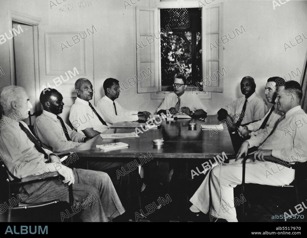 The House Of Representatives Electoral Rules, 1953The Electoral Commission in Session.The Cairo Agreement provided, so far as the elections are concerned, that"there shall be a Mixed Electoral Commission of seven members. These shall be three Sudanese appointed by the Governor-General with the approval of his Commission, one Egyptian citizen, one citizen of the United Kingdom, one citizen of the United States of America, and one Indian citizen."The Election Commission in session: Left to right  Mr. J. C. Penney, C.M.G...... United Kingdom member, Mr. Gordon Bulli ....... Sudanese member, El Sayed Khalafalla Khalid ..... Sudanese member, El Sayed Hassan Ali Abdallah ..... Secretary of the Commission, H.E. Mr. Sukumar Sen ... Indian member and Chairman of the Commission, El Sayed Abd Es Salaam el Khalifa Abdullahi, O.B.E... Sudanese member, Col. Abd el Fattah ....... Egyptian member, Mr. Warwick Perkins ...... United States member. November 10, 1954.