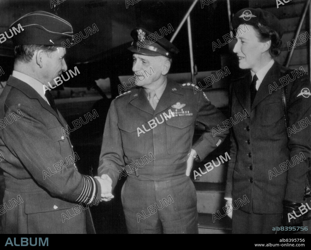 Sir Arthur Tedder Arrives -- Sir Arthur Tedder, (left), of Royal Air Force, is greeted at the National Air port today Gen. Carl A. Spaatz (centre), commander of the Pacific Strategic Air forces, as Lady Tedder (right), Looks on. The Tedders flew the Atlantic for an extended visit here. November 27, 1945. (Photo by AP Wirephoto).