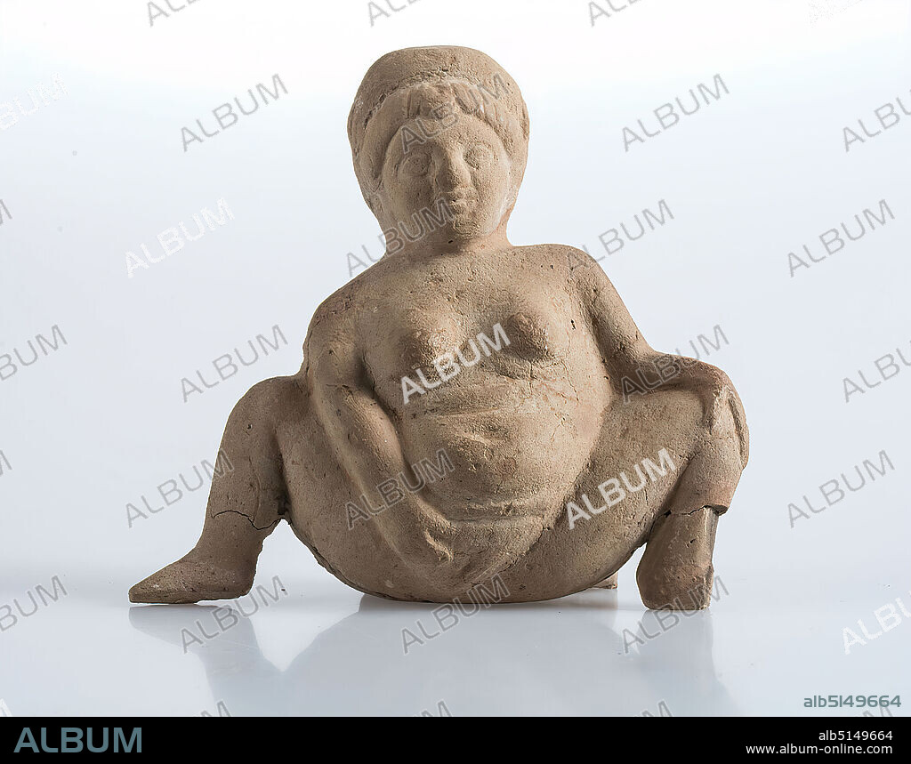 Baubo, clay, hand-modeled, fired (ceramic), clay, Total: Height: 9.5 cm; Width: 10.3 cm; Depth: 5 cm, ceramic, nude, nude, nude, unclothed, (almost) nude, female nude, squatting, stooped figure, delivery, birth, Hellenism, The small, plump and nude female figure has her legs spread to the side in birthing posture, the feet put on, grasps the shame with her right hand. The left hand is placed on the knee. On the head she wears a wreath. Figures of this motif are called Baubo (Greek: lap). Because of the thick belly and the unusual sitting posture with exposed shame, one assumes that she is depicted as a woman giving birth. While the left hand rests on the thigh, the right hand helps itself to bring the child into the world. This curious representation is generally understood as a symbol of fertility, or more precisely as a reference to the ability to bear children. Presumably the ominous statuette was given to women giving birth to protect the mother and the unborn child. The figure belongs to the group of the so-called Fayum terracottas. In Alexandria, the international, Greek-influenced center of Egypt, lives a multicultural society of Egyptians, Orientals, Greeks, Romans, Jews and others, whose different religious ideas are gradually blending together. Insights into this world of faith are provided by the so-called Fayum terracottas. They are part of the religious household, children's toys, knick-knacks, but also cult symbols, grave goods, pilgrimage images, votive offerings and magical objects for banishing evil forces. They can be found in houses, graves and sanctuaries.