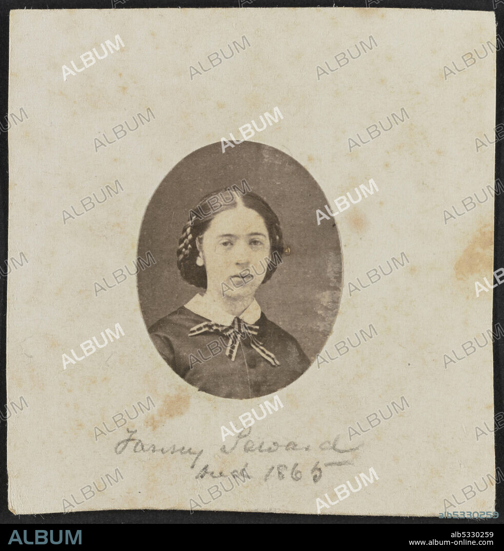 Albumen print of Fanny Seward shown in bust portrait. The print is cut in an oval and adhered to a paper mount. Seward is facing the camera with her hair parted at the center and gathered in a snood behind her head. She wears a dark colored bodice, white standard collar, and a light and dark colored ribbon is tied in a bow at the front of her neck.;Handwritten in graphite on the bottom center of the mount is the text "Fanny Seward / died 1865".;The photograph is housed in the album 2017.30. The album page has a triple-lined, gold border framing the print.