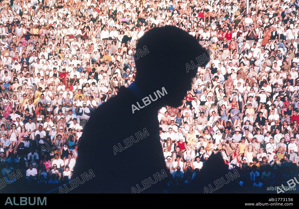 Robert Kennedy against the light. The American Democratic Senator Robert Kennedy taking part in a public event. His silhouette is in the shade. Usa, 1960s.