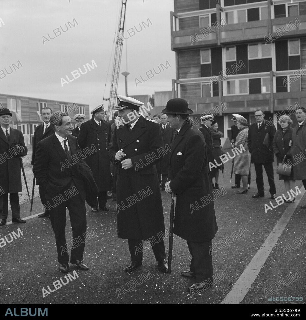 JOHN LAING PLC. Royal Navy housing, Gosport, Hampshire, 06/12/1966. A group of people including staff from the Royal Navy at the opening of married quarters in Gosport. This Armed Services' housing estate of 1000 12M Jespersen flats and houses was built by the South London Region of Laing's construction company for Royal Navy families. An article and photographs about the event were published in January 1967 in Laing's monthly newsletter 'Team Spirit'. The Commander-in-Chief of Portsmouth, Admiral Sir Frank Hopkins, is seen with two Royal Navy VCs, Jame Joseph Magennis (left) and Thomas William Gould (right) who had streets on the estate named after them.
