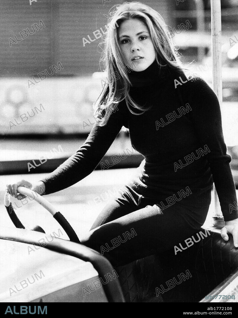 Portrait of Ottavia Piccolo. The Italian actress Ottavia Piccolo sitting on a bumper car in an amusement park. Milan, November 1972.