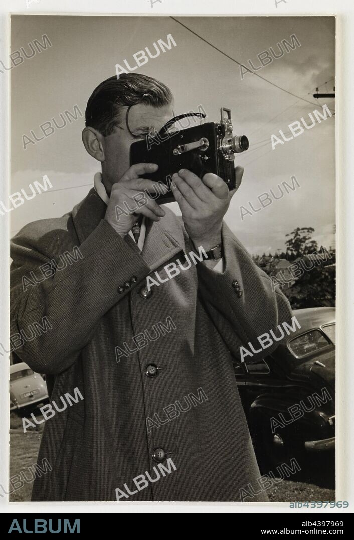 Photograph - Ken Turner Using Kodak Camera, Melbourne, circa 1940s, Black and white photograph of Kodak Australasia Pty Ltd employee Ken Turner using a Kodak movie camera circa 1940s. Ken was an amateur photographer in his spare time. Ken Turner worked for Kodak Australasia from 1938 to 1981, first in processing and then customer service. Ken's son Neil later had a long career at Kodak Australasia, based at Coburg. This object complements the Kodak Heritage.