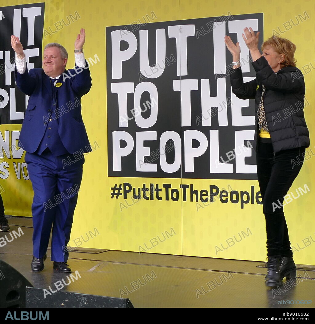 Anna Soubry and Ian Blackford, Members of Parliament, at the 'People's Vote' march in Parliament Square, London. The People's Vote march took place in London on 23 March 2019 as part of a series of demonstrations to protest against Brexit, call for a new referendum, and ask the British Government to revoke Article 50. It brought to the capital hundreds of thousands of protestors, or over a million people according to the organizers. Anna Soubry is a British politician, barrister and journalist. She has been the Member of Parliament (MP) for Broxtowe in Nottinghamshire since the 2010 general election, and was first elected as a Conservative before leaving the party to join The Independent Group in February 2019. Ian Blackford is the SNP leader at Westminster.
