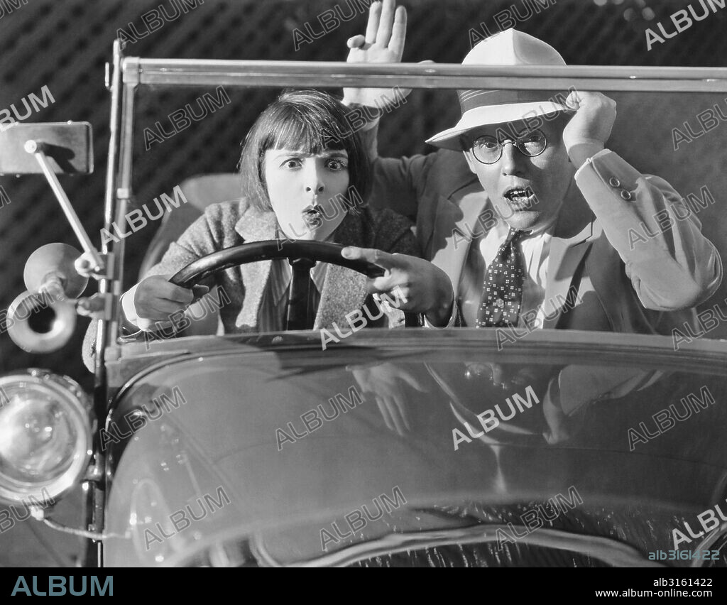 Hollywood, California: c. 1926 Actress Colleen Moore takes Richard Rowland, head of First National Pictures, out for a quiet spin down Hollywood Boulevard.