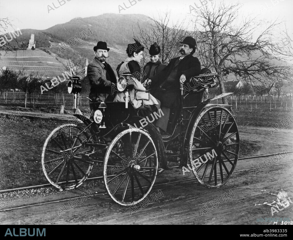 Karl Benz with his wife Bertha in a Benz-Viktoria, 1893. Karl Benz is on the right sitting next to his wife. His daughter sits opposite him next to a colleague Fritz Held. Benz's first car had only had three wheels, in order to aid steering. The Benz-Viktoria was his first car to have four wheels, and was manufactured by his company Benz and Co.