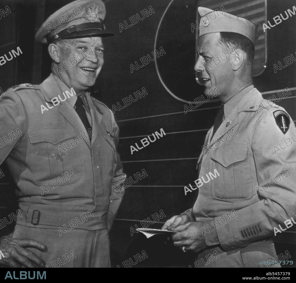 Happy Mood -- Gen. Dwight D. Eisenhower (left) laughs as he talks with an aide. Maj. Craig Cannon, Wilmington, Del., at Union Station today after the army chief of staff disclosed he has accepted the Presidency of Columbia University in New York, effective next year. Gen. Eisenhower was at the station with Mrs. Eisenhower who left for Boone, Ia., and the beside of an aunt who is ill, Miss Edda Carson. June 24, 1947. (Photo by AP Wirephoto).
