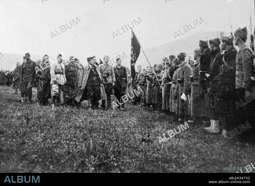 marshal Tito handing flag to the 1st proletarian brigade in Yugoslavia during ww2.