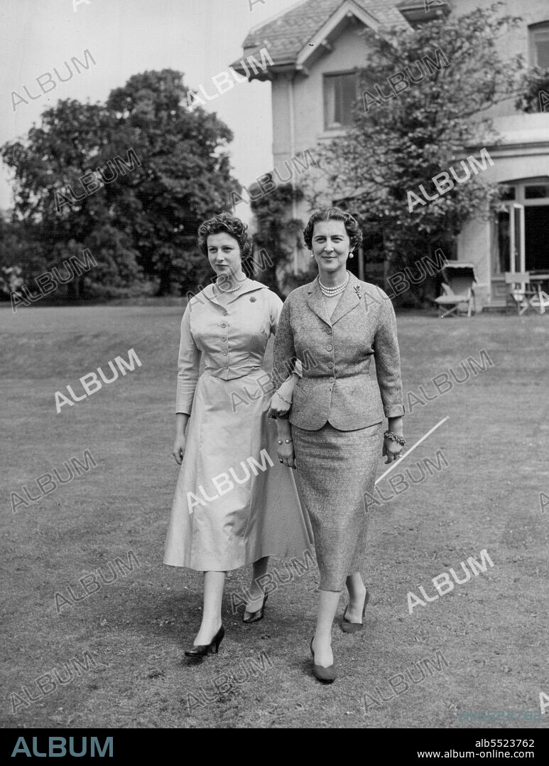 The Duchess and her Daughter at Home -- Arm in arm, the Duchess of Kent and Princess Alexandra stroll in the grounds of their home at Iver to-day.These ' at home ' pictures of the young and attractive Princess Alexandra and her equally attractive mother, the Duchess of Kent, were made at their country residence at The Coppins, Iver, Buckinghamshire, to-day (Friday). Apart from a brief ' finishing ' stay in Paris, Princess Alexandra has spent most of her 17½ years at The Coppins, her mother's home since 1936.Since returning from Paris, Princess Alexander has been gradually initiated into the social and public duties of the Royal family and, sometimes with her mother and sometimes alone, has carried out several official engagements. July 09, 1954. (Photo by Reuterphoto).