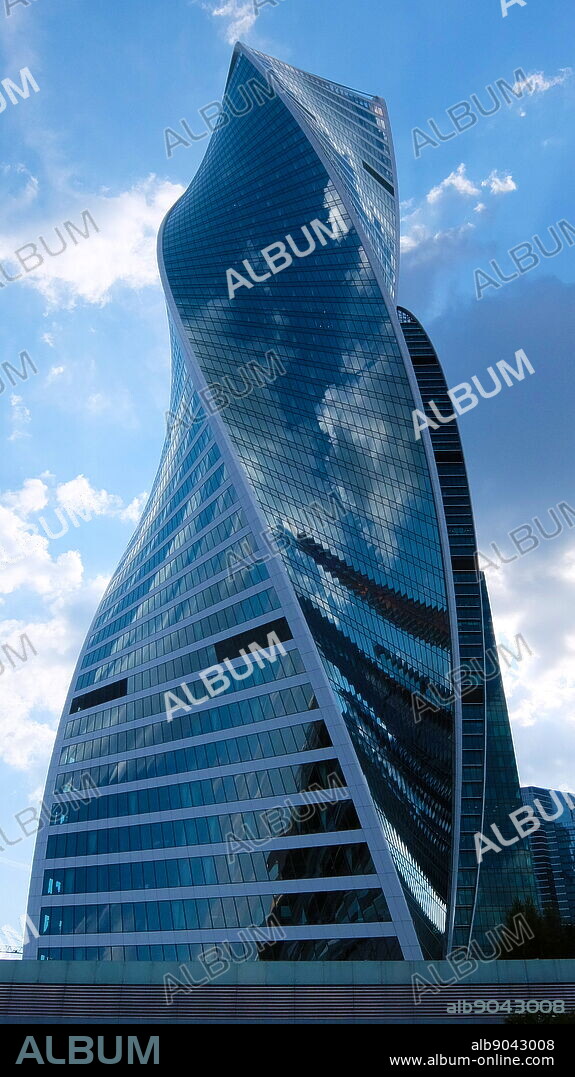 The Evolution Tower skyscraper, located in the Moscow International Business Center in Moscow, Russia. The 55-story office building has a height of 246 metres (807 ft) and a total area of 169,000 square metres (1,820,000 sq ft). Noted in Moscow for its futuristic DNA-like shape, the building was designed by British architect Tony Kettle in collaboration with University of Edinburgh's Professor of Art Karen Forbes. Construction of the tower began in 2011 and completed in late 2014.