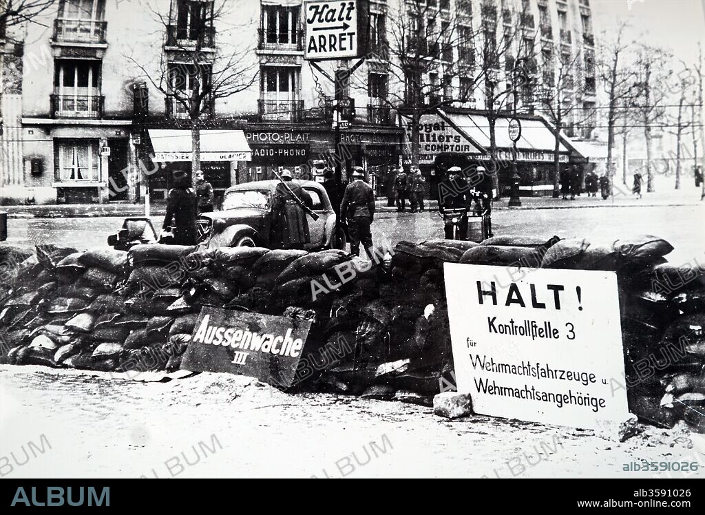 Photograph of German soldiers searching a vehicle at a road block in Paris, after the Invasion of France in 1940, in World War Two. Dated 20th Century.