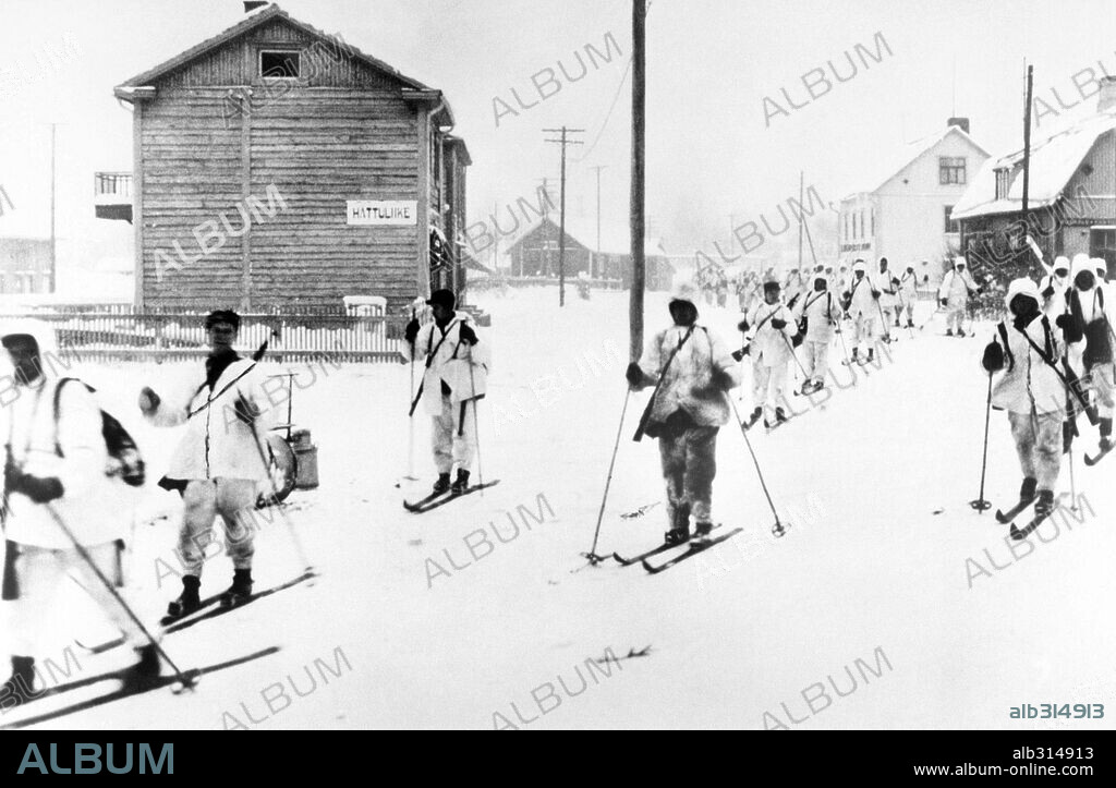The war in Finland in 1940. A finnish ski-patrol passing through a small town on the Eastern front.