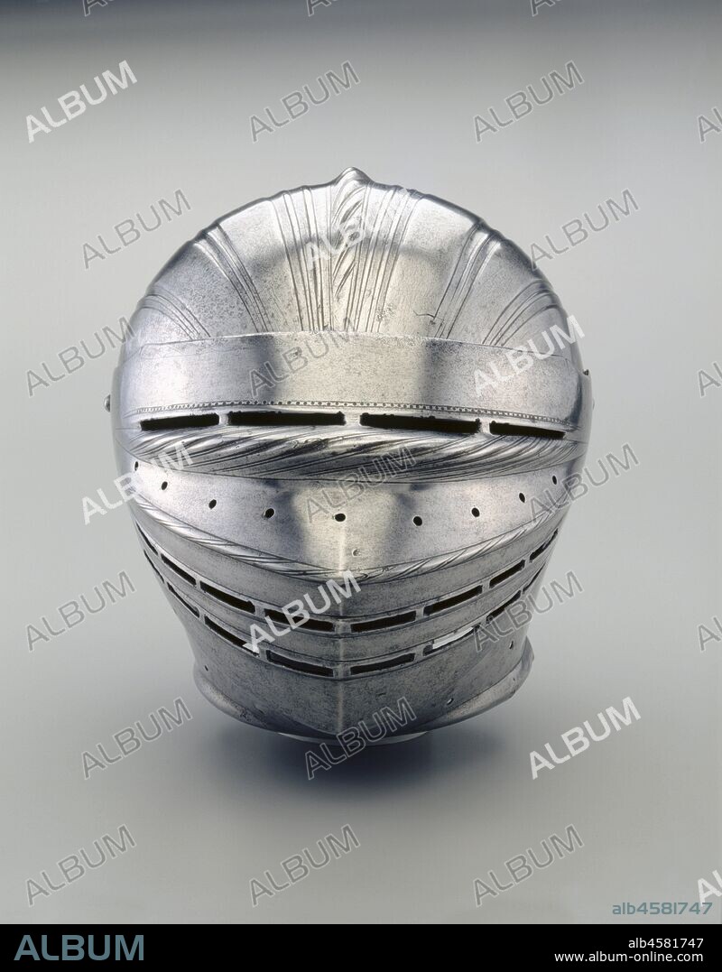 Field Armor in Maximilian Style: Helmet, c. 1510-1515. Most of the elements of this armor were made together, forming a single suit. The lower legs contain some modern restorations. The helmet is believed to be the work of the esteemed Augsburg armorer, Lorenz Helmschmied, who was active at the Hapsburg, Mantua, and Urbino courts between 1467 and his death in 1515.