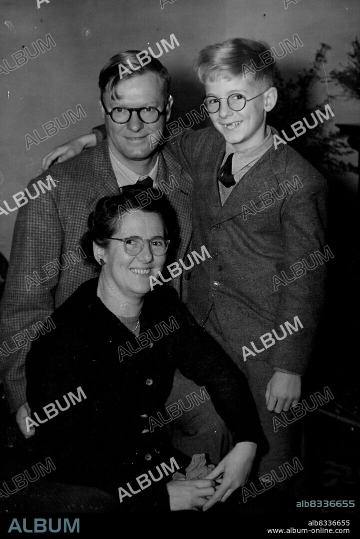Designer of Britain's atom bomb, Dr. William Penney who is be Sir William, at home with his wife and son Christopher. Eleven-year-old Christopher was in bed when the announcement of his father's knighthood was made and die not hear about it until today, when this picture was taken at their west Norwood home. October 24, 1952. (Photo by Daily Mail Contract Picture).