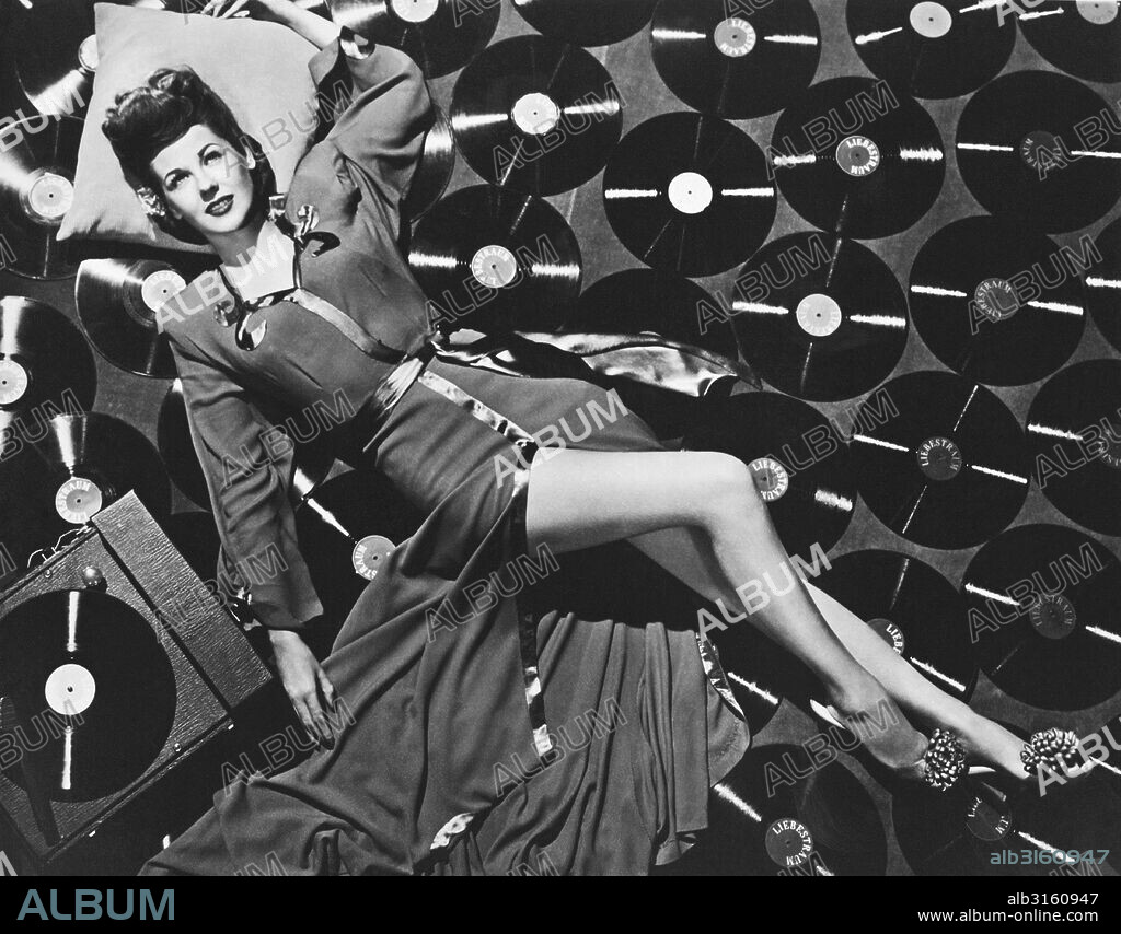 Hollywood, California: c. 1951 Actress and singer Marie 'The Body' McDonald lies seductively on the floor surrounded by and listening to a record album of Liebestraum by composer Franz Liszt.