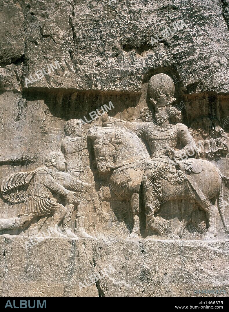Iran. Naqsh-e-Rustam. Necropolis. Sassanid period. The triumph of Shapur I (241-272) (on horseback). Shapur's victory over  Roman emperors Valerian (kneeling) and Philip the Arab.