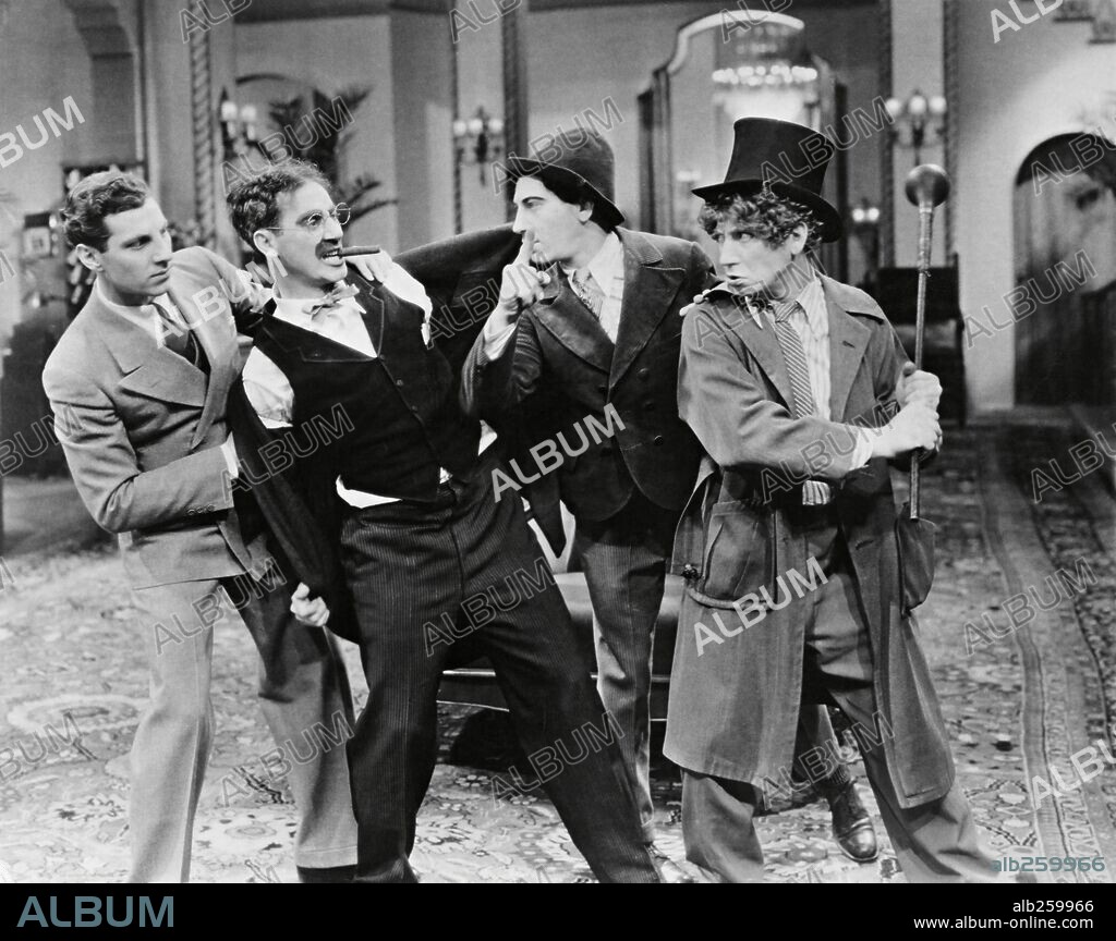 LOS HERMANOS MARX, CHICO MARX, GROUCHO MARX and HARPO MARX. CHICO MARX, GROUCHO MARX, HARPO MARX and THE MARX BROTHERS in THE COCOANUTS, 1929, directed by JOSEPH SANTLEY and ROBERT FLOREY. Copyright PARAMOUNT PICTURES.
