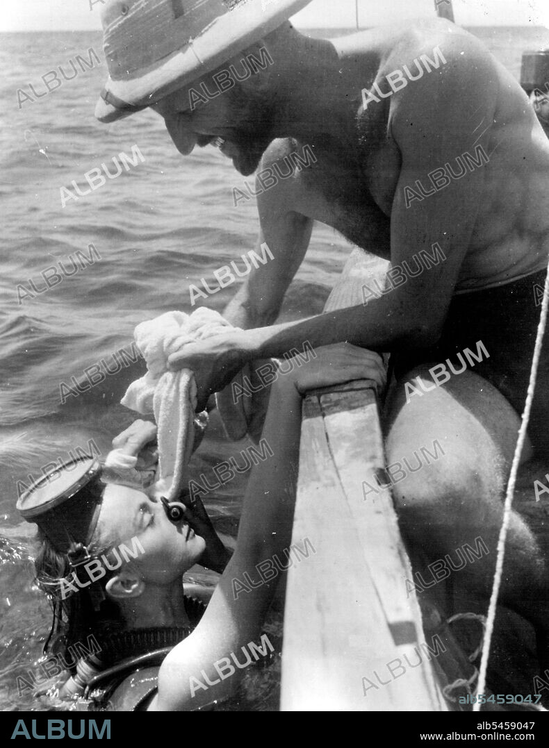 Dr. Hans Hass.Lotte Hass surfaces for a rest during a diving expedition on the Barrier Reef. February 25, 1953.