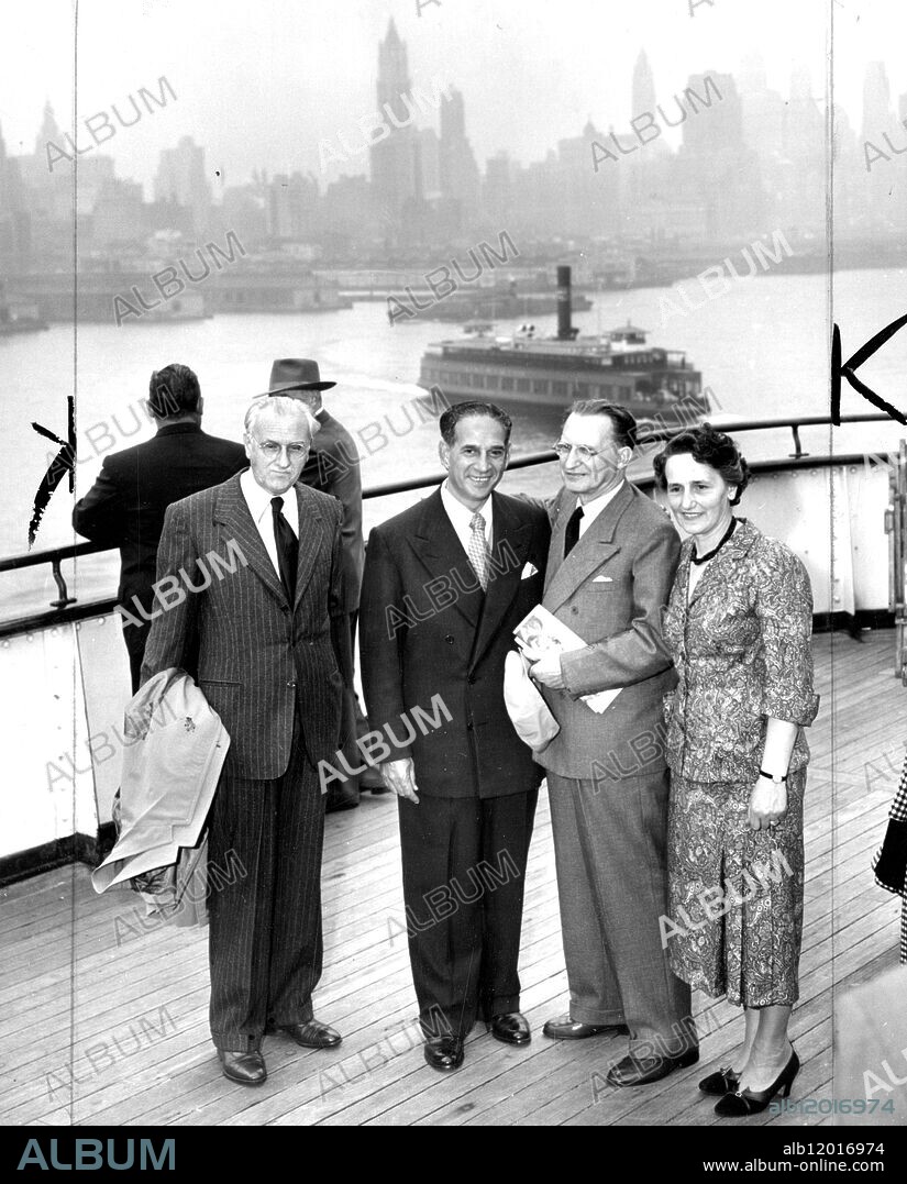 New York Mayor Impellitteri greets Italian Premier Alcide De Gasperi upon his arrival aboard the Queen Elizabeth. At left is Italian Ambassador to the U.S. Alberto Tarchiani, and right is the premier's wife. DeGasperi is en-route to the North Atlantic Treaty Organisation meeting in Ottawa, Canada. 11 September 1951.