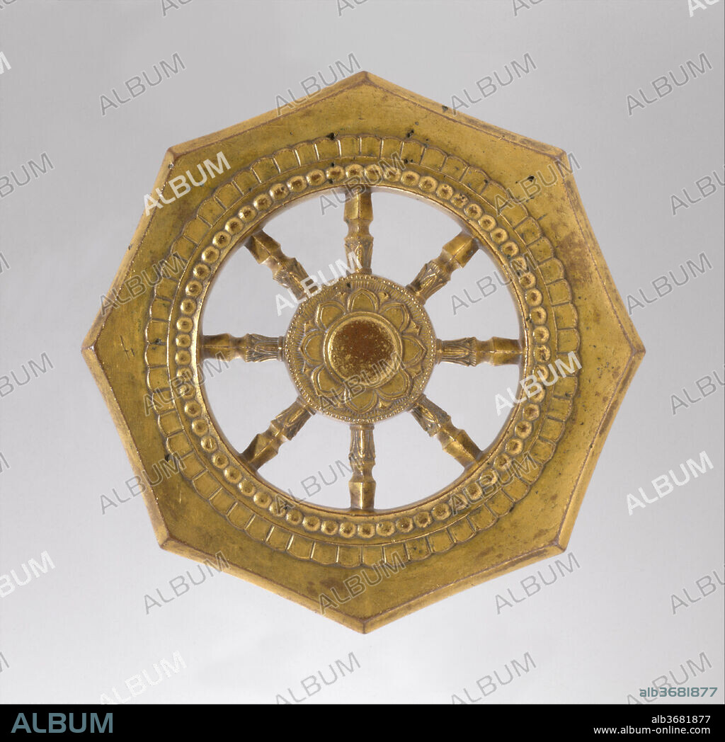 Wheel of the Buddhist Law (Rinpo). Culture: Japan. Dimensions: Diam. 5 in.(12.7 cm);  Th. 3/8 in. (11 cm); Wt. approx. 1.2 lbs (530 g.). Date: late 13th century.
This bronze ritual object connected with Esoteric Buddhism symbolizes the Wheel of the Law (Sanskrit: dharmachakra). In Buddhist texts and rituals, the phrase "turning the wheel of the law" refers to the act of teaching by the Buddha Shakyamuni. Each of the eight spokes and eight corners represents one of the moral admonitions of the Noble Eightfold Path, and the central section depicts a lotus flower with eight petals.
