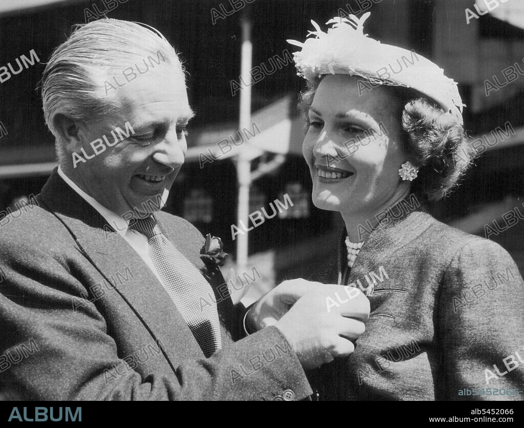 ***** Harold Holt, Federal Minister for Labor, presents ***** Kangaroo pin to Mrs. Richard Nixon, wife of the ***** of the United States at the Melbourne Cricket *****. October 23, 1953.