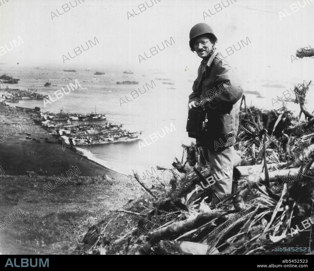 Rosenthal Covers Iwo Landing -- Joe Rosenthal, of the Associated Press, Photographer with the wartime still picture pool, looks over the scene at Iwo Jima, from which he has sent some of the most Graphic Pictures of the Pacific war. Today, in a by-Lined story he tells of events leading up to the Picture of A group of Marines Planting the U.S. Flag a top Mt. Suribachi. March 07, 1945. (Photo by AP Wirephoto).
