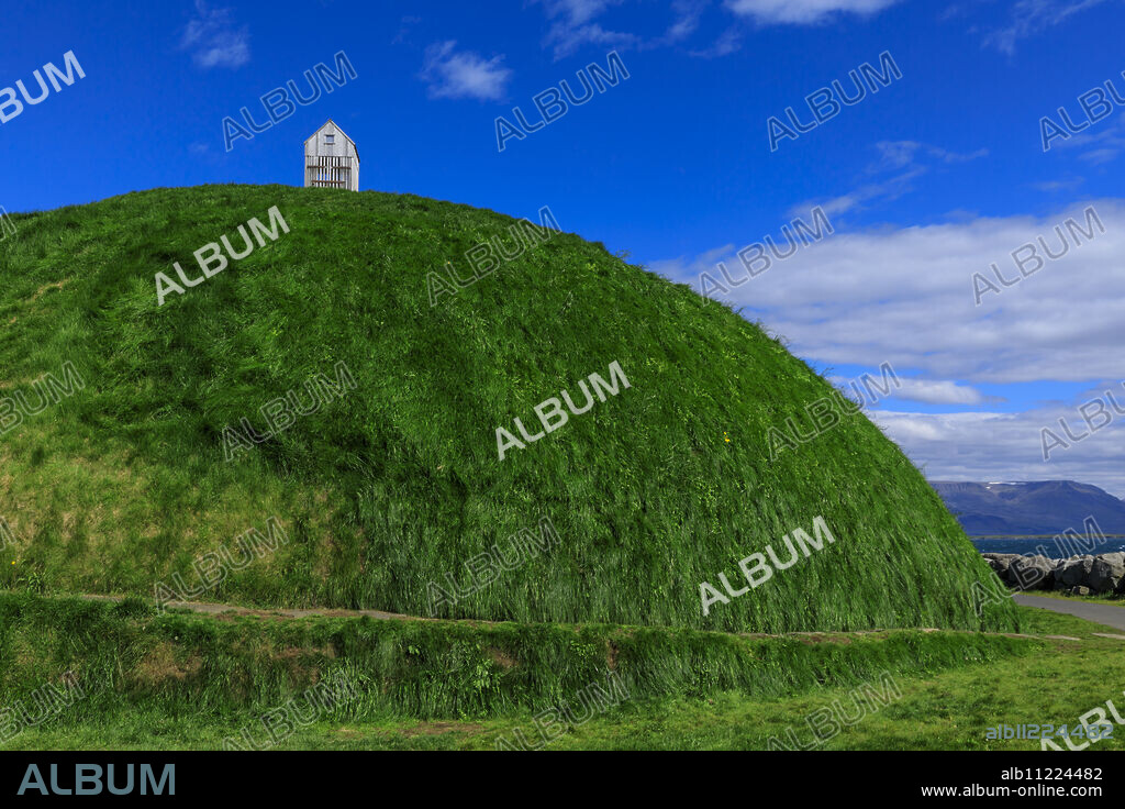 Thufa, green mound, blue sky, little house or fish drying shed in summer, Mount Esja, Old Harbour, Reykjavik, Iceland, Polar Regions.