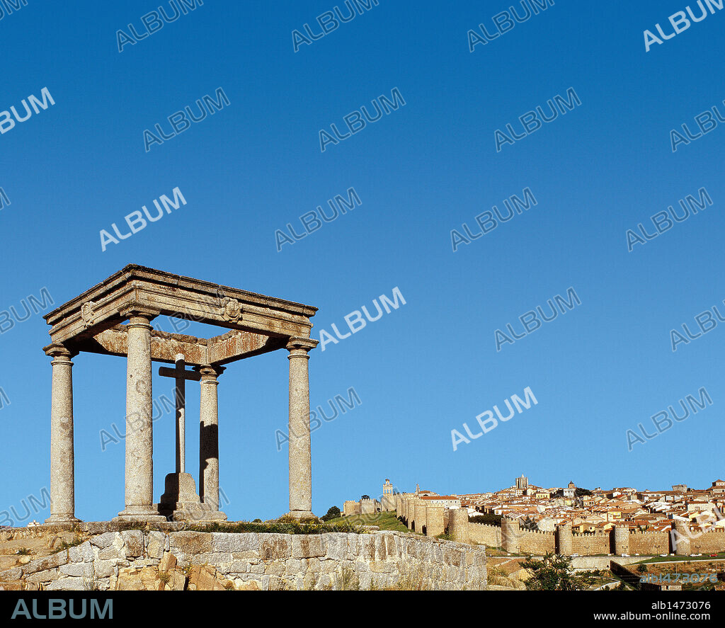 CASTILLA-LEON. AVILA. Vista de LOS CUATRO POSTES, humilladero abierto formado por cuatro pilares de granito que rodean una sencilla cruz, construido en el siglo XVI por el maestro Francisco de Arellano. Al fondo, panorámica de la ciudad rodeada por la muralla del siglo XII. España.