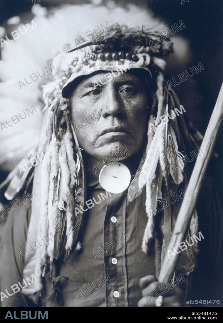 Edward S. Curtis Native American Indians - Apsaroke man, half-length portrait, wearing headdress circa 1905.
