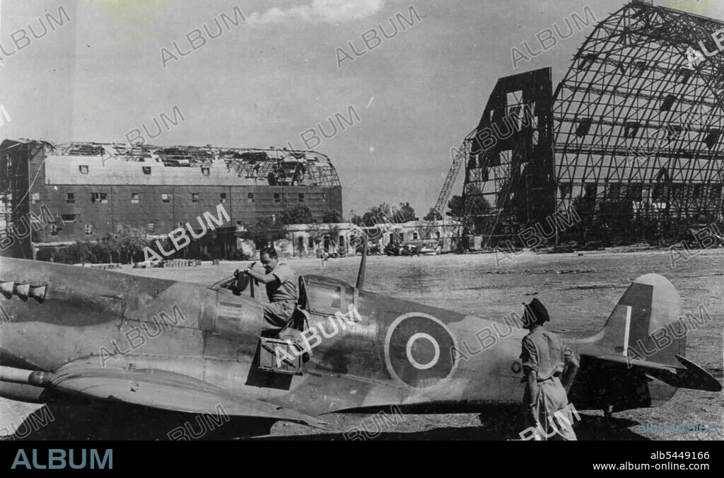 Air Vice Marshal Harry Broadhurst Inspects Italian Airfield. Photo shows: A.V.M. Harry Broadhurst climbing into his spitfire after the inspection. A.O.C. Desert Air Force, Air Vice Marshal Harry Broadhurst visited Italian Airfields in allied hands. His tour of inspection was made in his own spitfire. December 20, 1943. (Photo by British Official Photo).