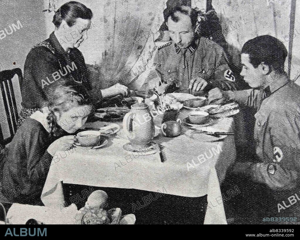 Nazi Storm Trooper Johann Laub eating at home with his family. The Sturmabteilung was the Nazi Party's original paramilitary wing. It played a significant role in Adolf Hitler's rise to power in the 1920s and 1930s.
