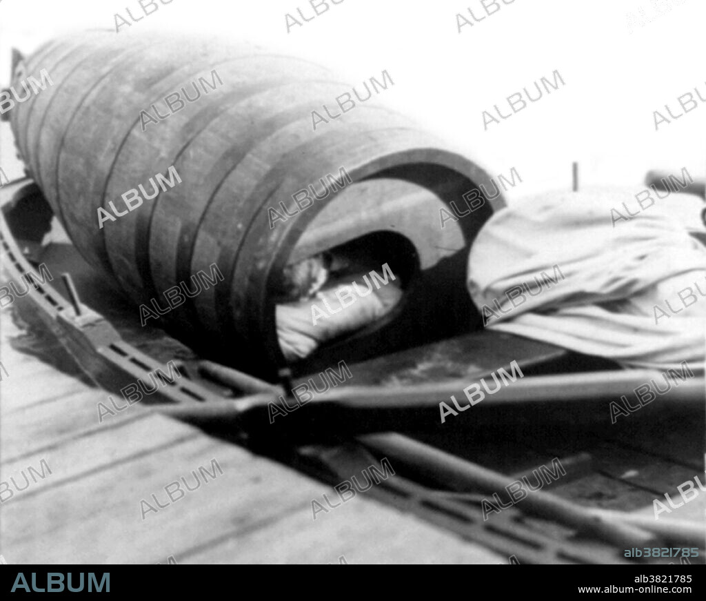 Taylor in her barrel to make her daring trip over Niagara Falls. Annie Edson Taylor (October 24, 1838 - April 29, 1921) was an American teacher. Desiring to secure her later years financially, she decided she would be the first person to ride over Niagara Falls in a barrel. Taylor used a custom-made barrel for her trip, constructed of oak and iron and padded with a mattress. On October 24, 1901, her 63rd birthday, the barrel was put over the side of a rowboat, and Taylor climbed in, along with her lucky heart-shaped pillow. After screwing down the lid, friends used a bicycle tire pump to compress the air in the barrel. The hole used for this was plugged with a cork, and she was set adrift near the American shore. The Niagara currents carried the barrel over the Canadian Horseshoe Falls. Rescuers reached her barrel shortly after the plunge. Taylor was discovered to be alive and relatively uninjured, except for a small gash on her head. She briefly earned money speaking about her experience, but was never able to build much wealth. She spent her final years posing for photographs with tourists at her souvenir stand, working as a clairvoyant, and providing magnetic therapeutic treatments to local residents. She died in 1921 at the age of 82. Cropped stereograph by Griffith & Griffith, October 24, 1901.
